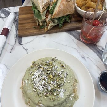 Fiore - Pistachio pancakes and chicken pesto sandwich with the jungle bird drinks. - New American Near Me - Miami, Florida Fiore - Pistachio pancakes and chicken pesto sandwich with the jungle bird drinks. - New American Near Me - Miami, Florida
