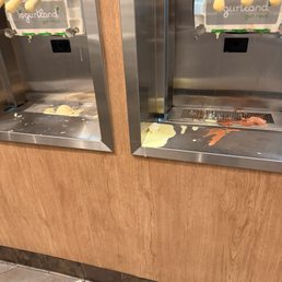 Yogurt dripping on the floor all messy. Yogurt dripping on the floor all messy.