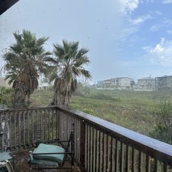 Beachcomber Apartments - Rain ain't gonna keep us away. #11 balcony
