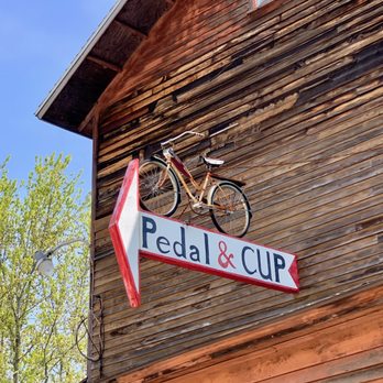 Pedal and Cup - a bicycle mounted on the side of a building - Bike Rentals Near Me - Springfield, Wisconsin