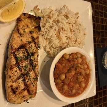 Galazio Restaurant - Char grilled salmon Fillet, olive oil, oregano, and lemon spices with Greek chickpeas, and rice pilaf  Salmon comes cook, medium - Mediterranean Near Me - La Plata, Maryland