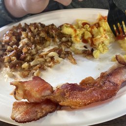 Hash browns, crisped to perfection. Eggs and bacon. Hash browns, crisped to perfection. Eggs and bacon.