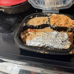 Enchilada meal and lactate taco wrapped in foil Placed inside the container on top of my meal