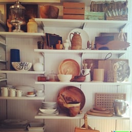 a shelf full of dishes and utensils