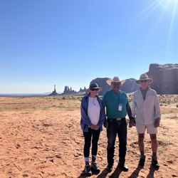 Sandstone Tours - Our guide John (center) with Totem Pole rock in the background, last climbed by Clint Eastwood