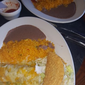 Guapo's Cocina & Bar - Taco and enchilada with huevos rancheros in the background. - Mexican Near Me - Gaithersburg, Maryland