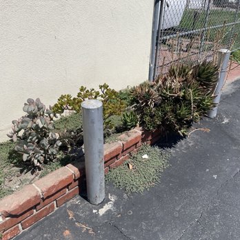 Under The Sun Gardening - a concrete pole in front of a house - Gardeners Near Me