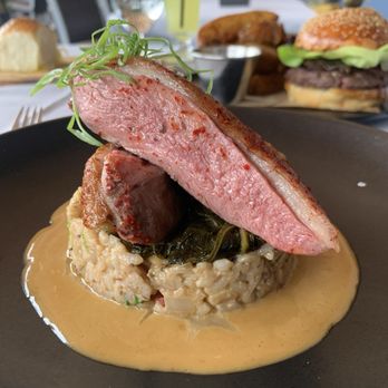 Bludorn - Duck - dirty rice topped with collard greens and foie gras emulsion - New American Near Me - Houston, Texas