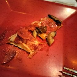 Grandad's Pizza & Pub - Piece of pepperoni & mushroom pizza.