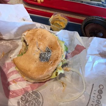 Burger King - a half eaten sandwich on a wrapper - Burgers Near Me - Elmira, New York