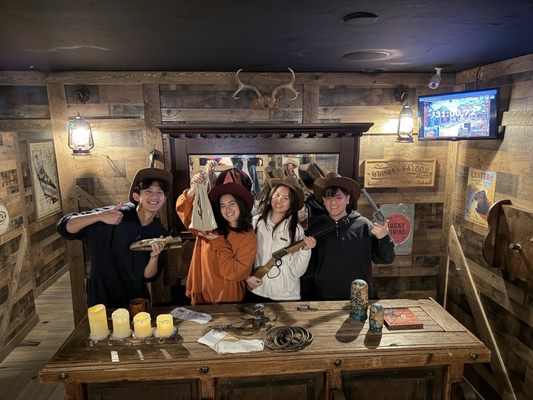 Holcombs Locks Gold Escape Room - Ol' Bill Holcomb's been hoodwinked! The fortune in gold that Bill dug out of these hills has been snatched out from under his nose, and he needs your help to get it back! Bear Valley's premiere prospector is lookin' for folks with sharp eyes and quick wits to scour the saloon where the theft took place for clues.
Do you have what it takes to find Holcomb's Lost Gold?
Difficulty: 6/10
Time: 60 minutes
Hints: 3
Recommended for kids?: Yes! Holcombs Locks Gold Escape Room - Ol' Bill Holcomb's been hoodwinked! The fortune in gold that Bill dug out of these hills has been snatched out from under his nose, and he needs your help to get it back! Bear Valley's premiere prospector is lookin' for folks with sharp eyes and quick wits to scour the saloon where the theft took place for clues.
Do you have what it takes to find Holcomb's Lost Gold?
Difficulty: 6/10
Time: 60 minutes
Hints: 3
Recommended for kids?: Yes!