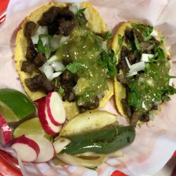 Fatty Boy Tacos - a person holding a plate of tacos - Food Delivery Services Near Me