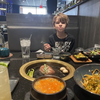 Honest Grill - My son enjoying a delicious meal. The soy bean stew was delicious and all the meats were top quality. - Barbeque Near Me - Centreville, Virginia Honest Grill - My son enjoying a delicious meal. The soy bean stew was delicious and all the meats were top quality. - Barbeque Near Me - Centreville, Virginia