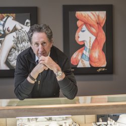 John Atencio in one of his store location with paintings that he created.