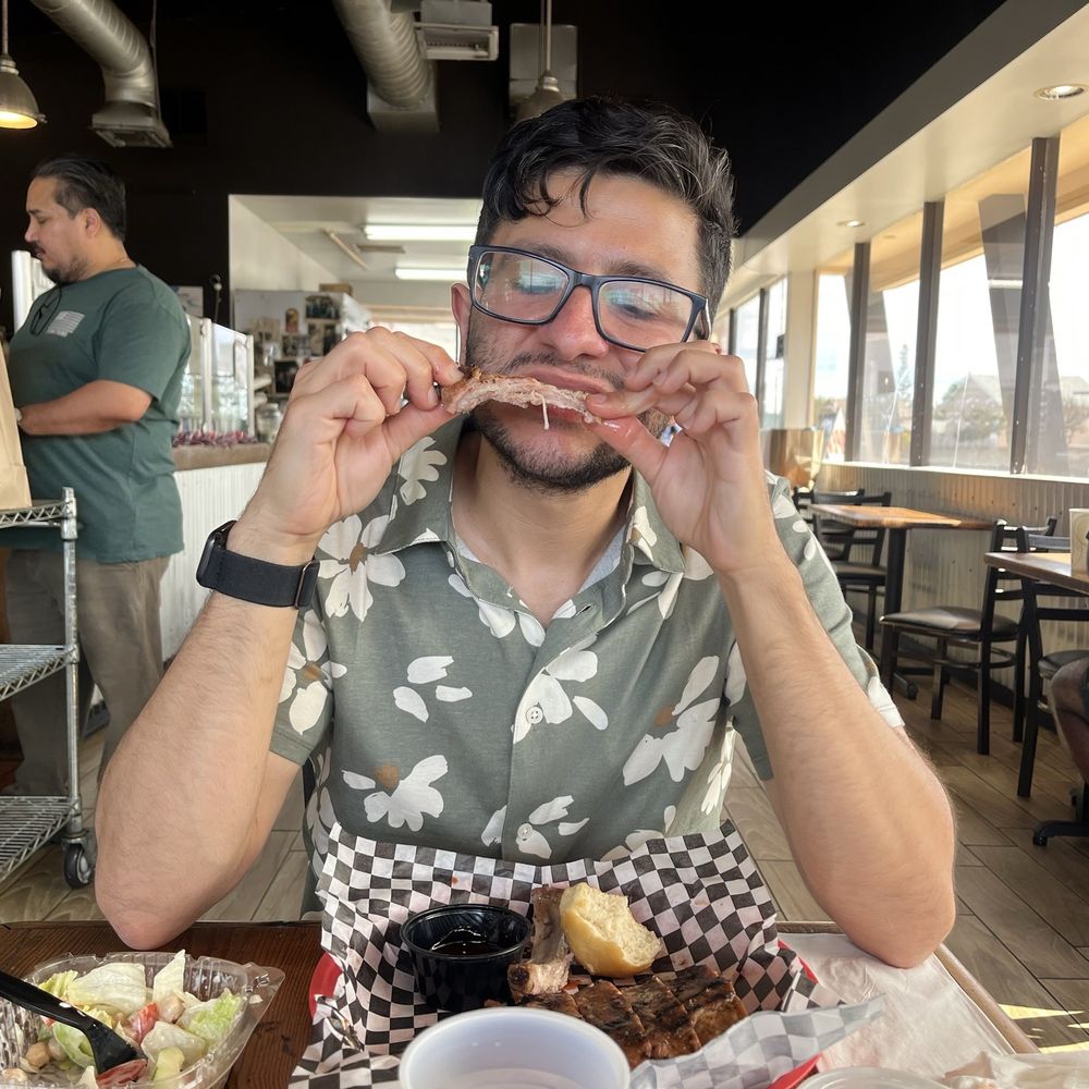 Rosie's BBQ Kitchen - Enjoying his rib.. - Barbeque Near Me - Chatsworth, California Rosie's BBQ Kitchen - Enjoying his rib.. - Barbeque Near Me - Chatsworth, California