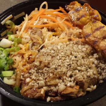 Krua Thai - Beef pad thai in a takeaway container, with a skewer of chicken satay. Just looking at this makes me want to order it again now. Super good. - Thai Near Me - Glenview, Illinois