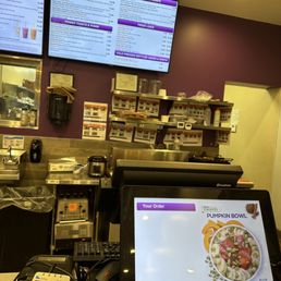 a restaurant counter with menus on the wall a restaurant counter with menus on the wall