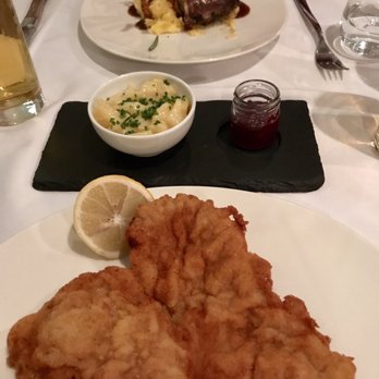 Pauli - Wiener schnitzel, potato salad and cranberry sauce. In the back is the lamb - cooked perfectly! - Austrian Near Me - Vienna, 9