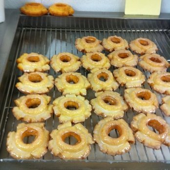 Donut Palace - a tray of glazed donuts on a grill - Donuts Near Me - Gonzales, Louisiana