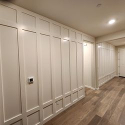 Architectural Woodworking - Custom Batten Board walls in Entry Hallway.