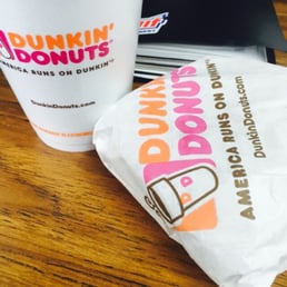 a cup of coffee and a bag of donuts