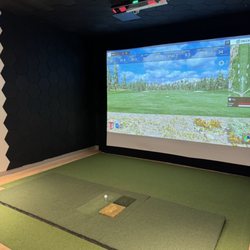 Another Nine - Uneekor Eye XO2 Simulators with fairway, rough, and sand hitting mats. Running E6 Connect with over 100+ courses available.