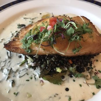 Waterscapes - Seared salmon on top of wilted kale and a pile of green lentils. Absolutely amazing! - New American Near Me - Myrtle Beach, South Carolina Waterscapes - Seared salmon on top of wilted kale and a pile of green lentils. Absolutely amazing! - New American Near Me - Myrtle Beach, South Carolina