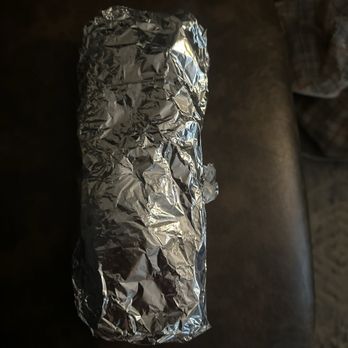 Palmitos Mexican Eatery - Breakfast burrito selection. It's pretty big. Using dining chair for size comparison - Mexican Near Me - San Diego, California