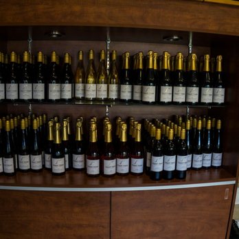 Giant Head Estate Winery - a wine shelf full of wine bottles - Wineries Near Me - Summerland, British Columbia Giant Head Estate Winery - a wine shelf full of wine bottles - Wineries Near Me - Summerland, British Columbia