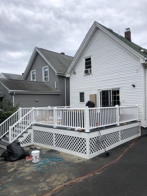 New Composite Deck in Everett, MA - When you add a deck to your home you are not only increasing the value of your home and utilizing your backyard, but you are also creating a place for friends and family to gather for years to come. Whether you want to host a barbecue or relax with a book in the sun, adding a deck to your home provides endless possibilities.
To begin this project our team demolished and installed brand new footings. Holes were dug 36 inches deep and filled with concrete. The footings, like the joist and all other components of the framework, were built with pressure-treated lumber. Pressure-treated lumber is an excellent choice for exterior projects because it is sturdy, but also moisture resistant. This is particularly important for the framework of the deck. If the framework were made out of regular wood the moisture of the ground would cause it to rot and deteriorate.
We always takes every precaution available to protect your home. One of the most important parts of building a deck is making sure that ledger board is installed with proper flashing. For this project our team installed 2″ x 8″ ledger board with copper flashing. The flashing acts as a barrier, preventing water from dripping into the seams of your house. Once all of the framework was complete our team could install the composite floorboards and railings.
While our team built the framework of this deck out of pressure-treated lumber, composite was used for all of the floorboards and railings. Composite is a great choice for exterior projects because, like pressure-treated lumber, it is water-resistant. In addition to a crisp look, and is also easy to clean.
Composite railings and floorboards are available in a variety of colors so you can be sure to find a color that works with the style of your home.
A white composite apron was also installed for this deck project. In order to make the design of the deck look cleaner, and to keep pesky animals from living underneath, our team installed custom-built lattice. This latticework was built out of pressure-treated wood. New Composite Deck in Everett, MA - When you add a deck to your home you are not only increasing the value of your home and utilizing your backyard, but you are also creating a place for friends and family to gather for years to come. Whether you want to host a barbecue or relax with a book in the sun, adding a deck to your home provides endless possibilities.
To begin this project our team demolished and installed brand new footings. Holes were dug 36 inches deep and filled with concrete. The footings, like the joist and all other components of the framework, were built with pressure-treated lumber. Pressure-treated lumber is an excellent choice for exterior projects because it is sturdy, but also moisture resistant. This is particularly important for the framework of the deck. If the framework were made out of regular wood the moisture of the ground would cause it to rot and deteriorate.
We always takes every precaution available to protect your home. One of the most important parts of building a deck is making sure that ledger board is installed with proper flashing. For this project our team installed 2″ x 8″ ledger board with copper flashing. The flashing acts as a barrier, preventing water from dripping into the seams of your house. Once all of the framework was complete our team could install the composite floorboards and railings.
While our team built the framework of this deck out of pressure-treated lumber, composite was used for all of the floorboards and railings. Composite is a great choice for exterior projects because, like pressure-treated lumber, it is water-resistant. In addition to a crisp look, and is also easy to clean.
Composite railings and floorboards are available in a variety of colors so you can be sure to find a color that works with the style of your home.
A white composite apron was also installed for this deck project. In order to make the design of the deck look cleaner, and to keep pesky animals from living underneath, our team installed custom-built lattice. This latticework was built out of pressure-treated wood.