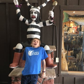 BBQ Outlaw - a young boy standing in front of a statue of a clown - Barbeque Near Me - Sedona, Arizona