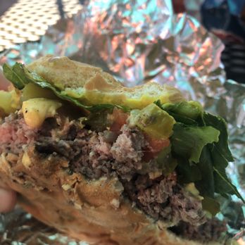 Tin Can Cafe - a hand holding a sandwich - Food Trucks Near Me - Ferndale, Michigan