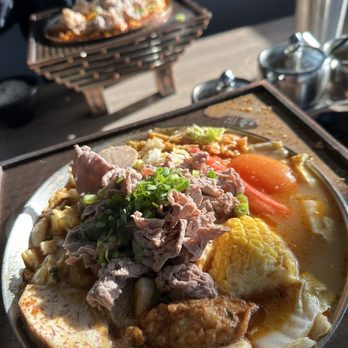 Tasty Pot - Beef hot pot & kimchi dumpling in the back. - Hot Pot Near Me - Aurora, Colorado Tasty Pot - Beef hot pot & kimchi dumpling in the back. - Hot Pot Near Me - Aurora, Colorado