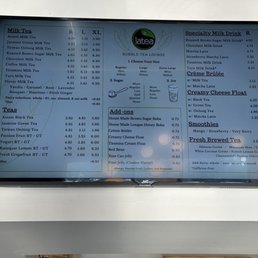 Menu - A digital menu screen at Latea Bubble Tea lists a variety of teas, milk drinks, and add-ons, with prices and options for customization.