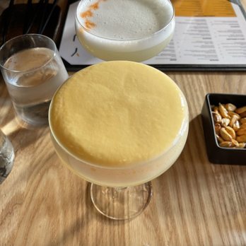 Yunta Nikkei - Traditional Pisco Sour (top), Passion Fruit Pisco Sour (bottom) - Peruvian Near Me - Charlotte, North Carolina Yunta Nikkei - Traditional Pisco Sour (top), Passion Fruit Pisco Sour (bottom) - Peruvian Near Me - Charlotte, North Carolina