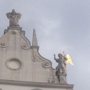 Kleines Café - Top of church for which plaza is named, with golden angel wings glistening in the sun - Coffee & Tea Near Me - Vienna, 9 Kleines Café - Top of church for which plaza is named, with golden angel wings glistening in the sun - Coffee & Tea Near Me - Vienna, 9