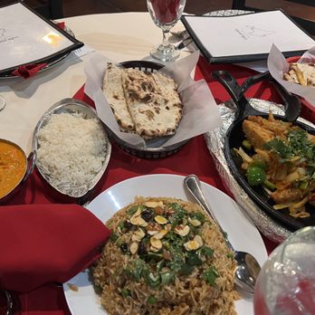 India Garden - Chicken Tikka Masala, Cheese Naan, Chicken Biryani (mountain of stir fried rice) Chicken Shish Kebab (far right on skillet). - Indian Near Me - Avondale, Arizona