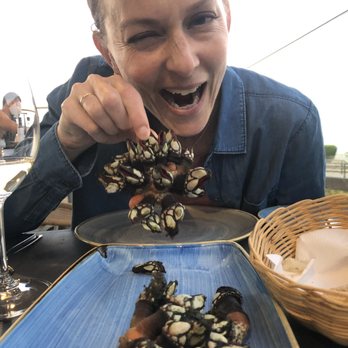 Restaurante O Camilo - A woman pirate eating percebes incorrectly. - Seafood Near Me - Lagos, 08