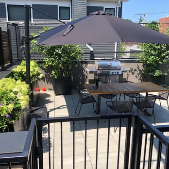 Urban Rooftops - a patio with a grill, table and chairs - Decks & Railing Near Me - Chicago, Illinois