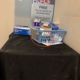 Empty vaccine bottle from a previous customer....filthy tablecloth.....broken dirty basket . Empty vaccine bottle from a previous customer....filthy tablecloth.....broken dirty basket .
