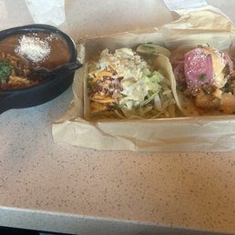 Rice and beans, fried chicken tender taco, fried shrimp taco.