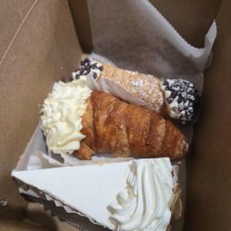 canolli, lobster tail, slice of cheesecake