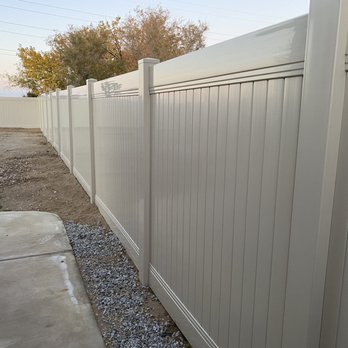 Fence Guys - Tan vinyl fence in the back yard. - Fences & Gates Near Me - Hesperia, California
