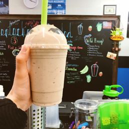 a hand holding a smoothie a hand holding a smoothie
