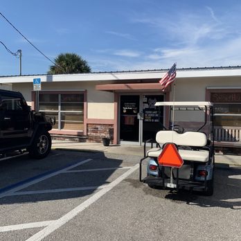 SmokeHouse - a golf cart parked in a parking lot - Smokehouse Near Me - Punta Gorda, Florida