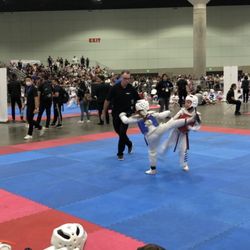 US Taekwondo Team - My daughter in blue sparring against a girl 3 years older, competing at the LA convention center.
