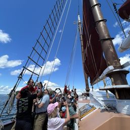 Sailing...volunteers helping raise the sails with staff Sailing...volunteers helping raise the sails with staff