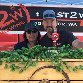 E2W Brewing - a man and a woman standing behind a barrel - Breweries Near Me - Olalla, Washington E2W Brewing - a man and a woman standing behind a barrel - Breweries Near Me - Olalla, Washington