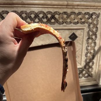 Winner's NY Pizza - a hand holding a slice of pizza - Pizza Near Me - Agoura Hills, California