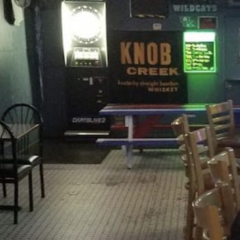 The Deuce - a man sitting at a table in a restaurant - Dive Bars Near Me - Louisville, Kentucky